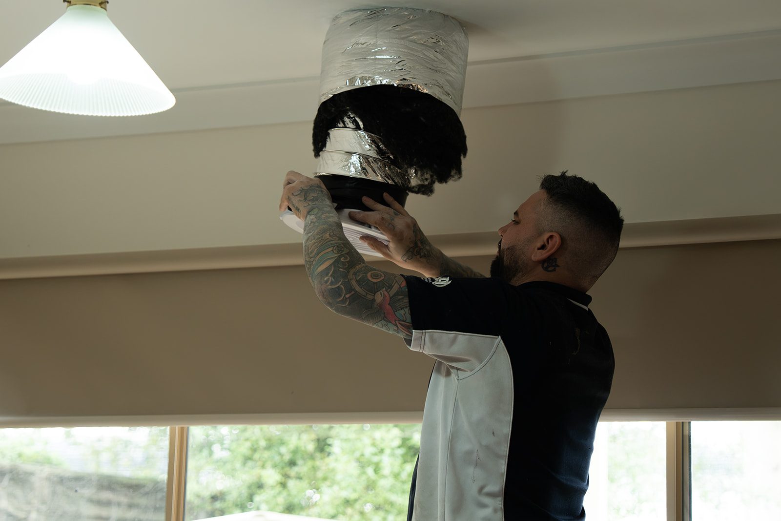 Ducted outlet being installed in a ceiling